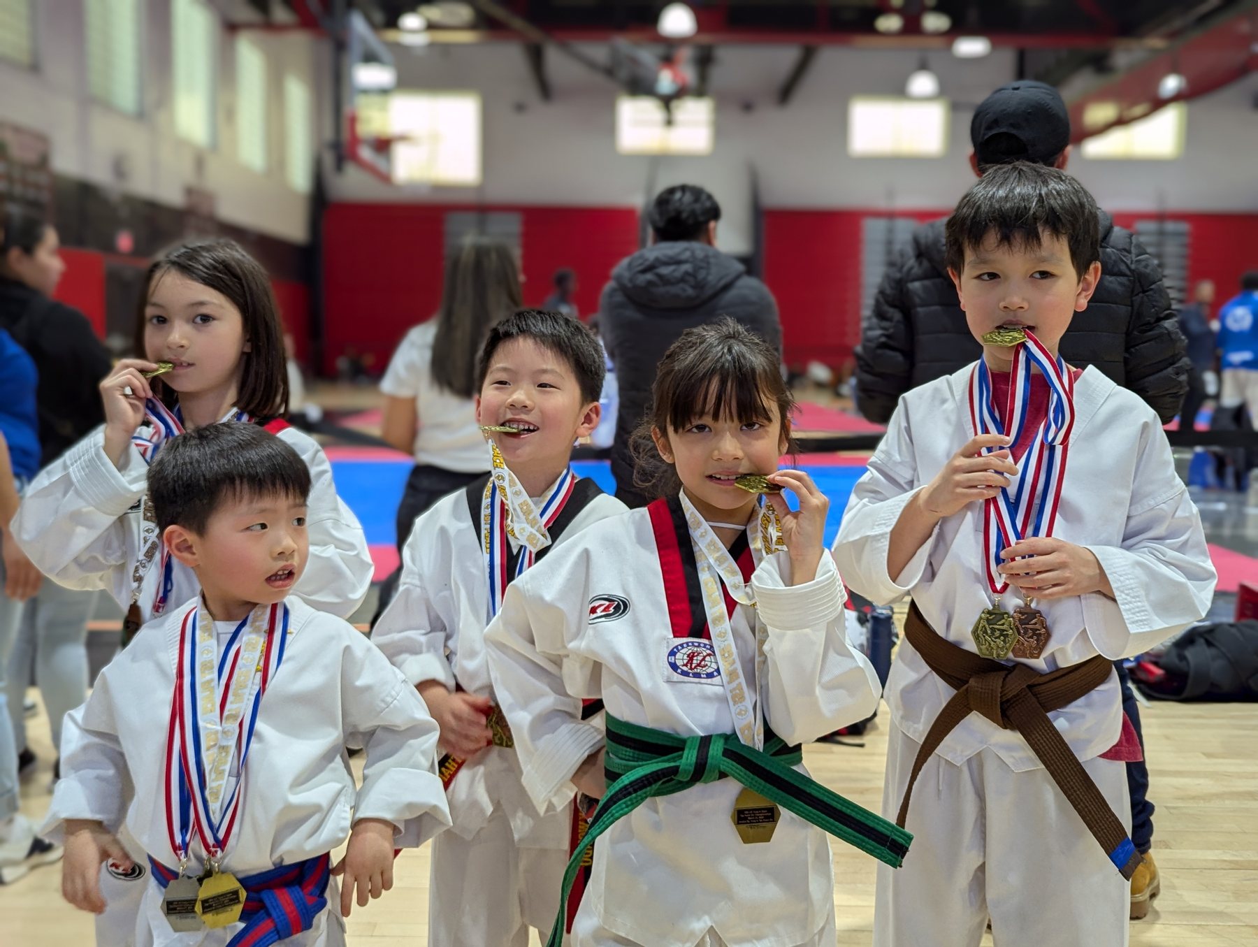 Young KT Taekwondo students celebrating together